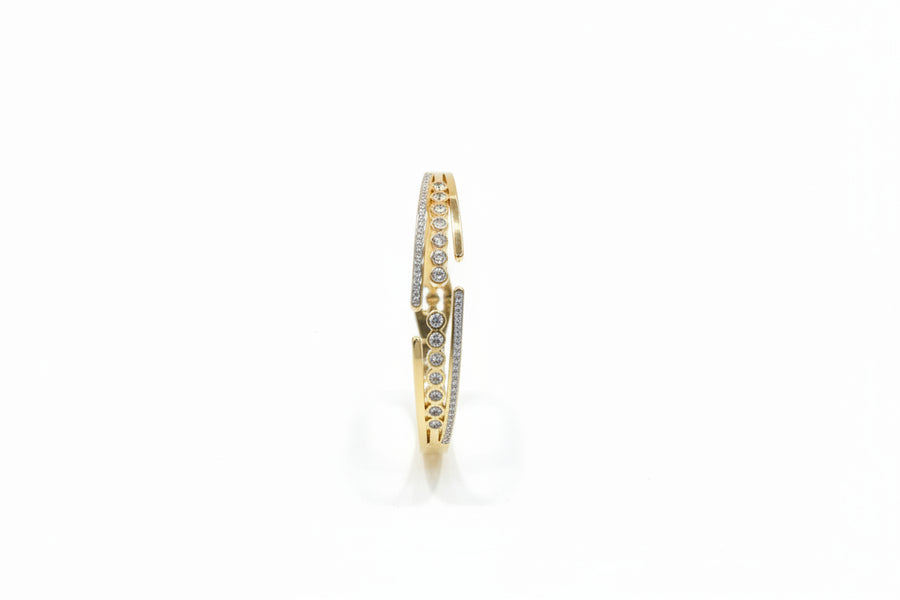 Solitaire line openable kada with pave zircon in gold finish held in hand