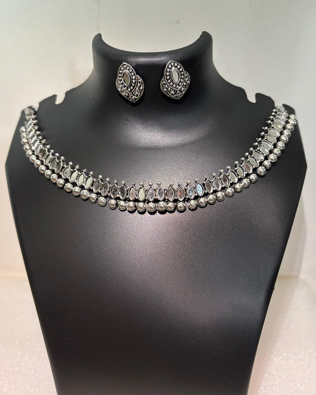 Oxidised necklace set with oval mirror-style stones, bead drops and matching stud earrings