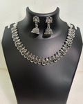 Oxidised teardrop motif necklace with engraved leaf details and matching floral jhumka earrings