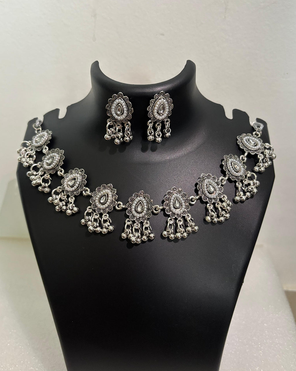 Oxidised teardrop tassel necklace with floral motifs, bead drops and matching teardrop earrings