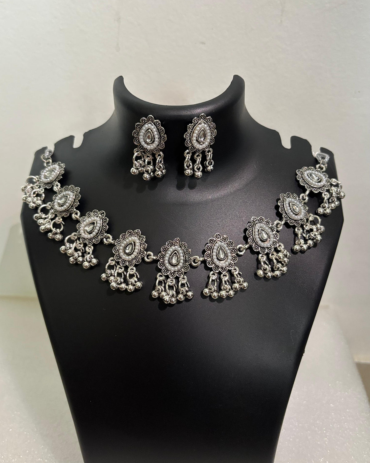 Oxidised teardrop tassel necklace with floral motifs, bead drops and matching teardrop earrings