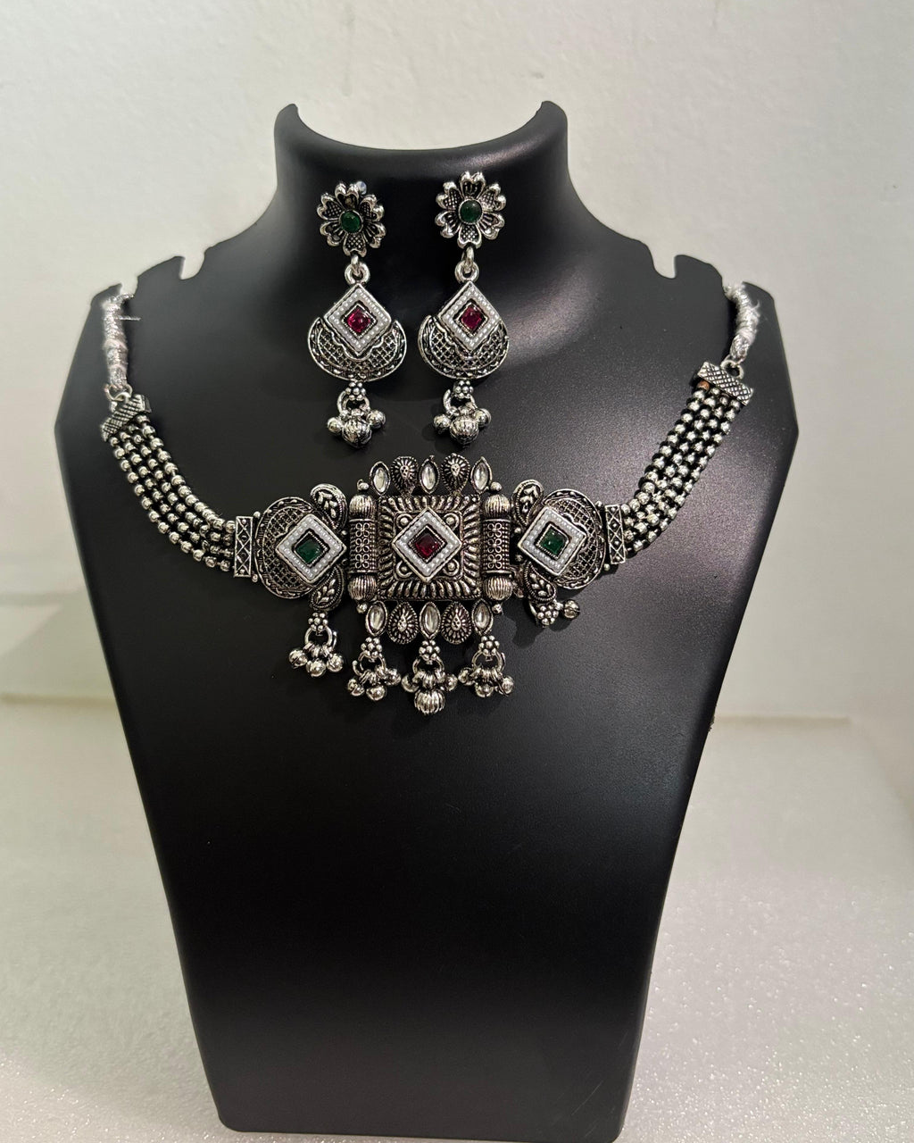 Oxidised statement choker necklace with geometric motifs, colourful stones, tassels and matching floral drop earrings