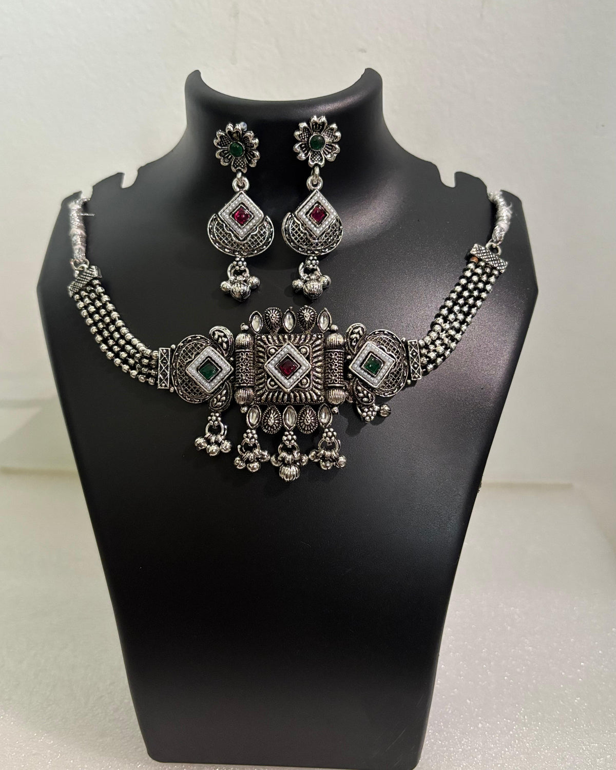 Oxidised statement choker necklace with geometric motifs, colourful stones, tassels and matching floral drop earrings