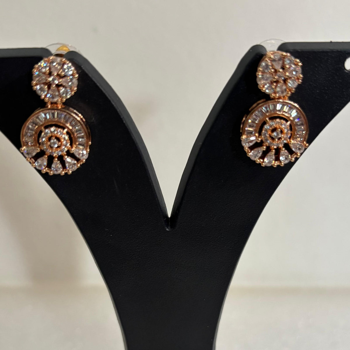 Premium anti-tarnish AD CZ arch drop earrings with sparkling floral studs in a gold-tone setting