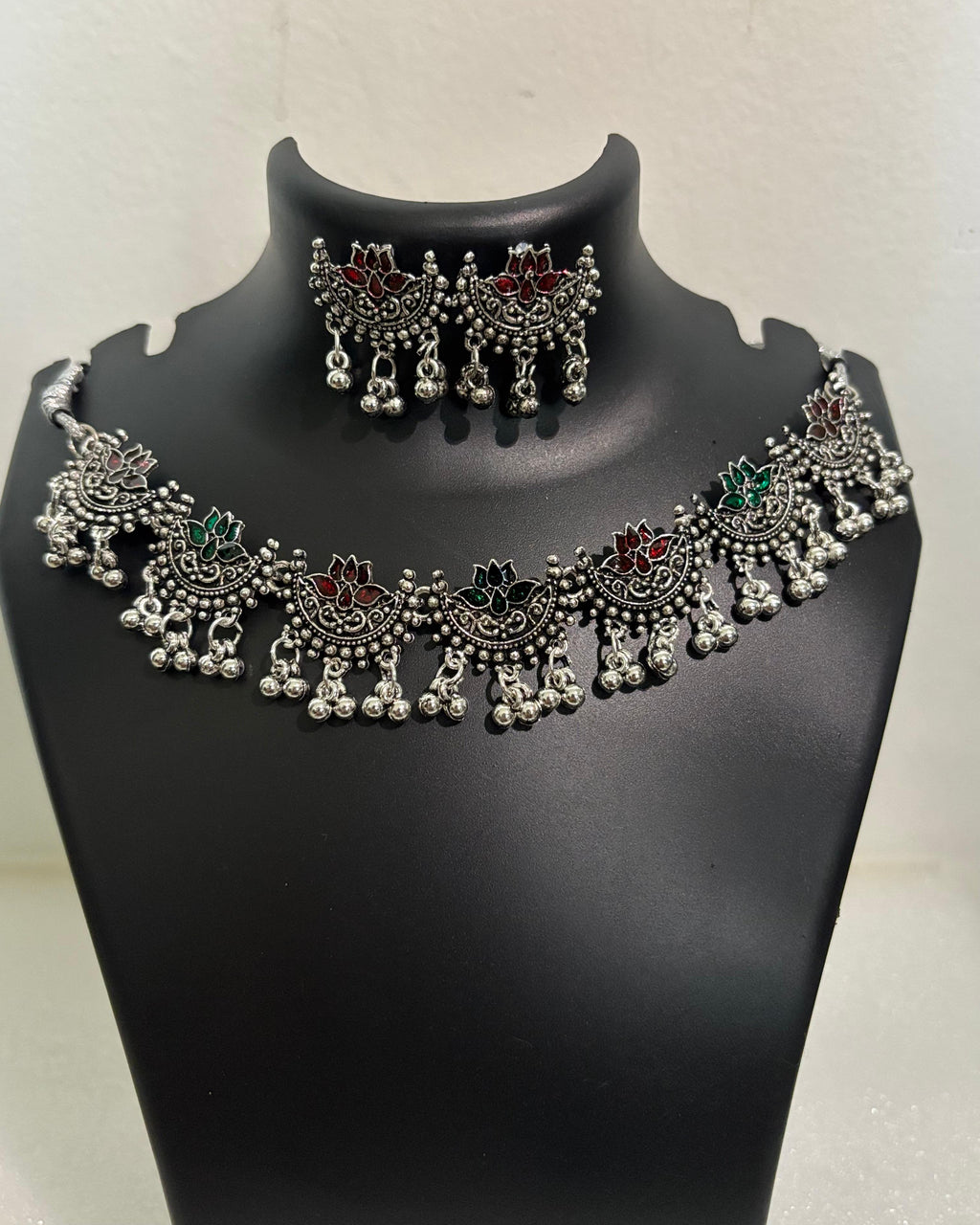 Oxidised lotus motif tassel necklace with coloured stone accents and matching lotus drop earrings