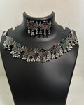 Oxidised lotus motif tassel necklace with coloured stone accents and matching lotus drop earrings