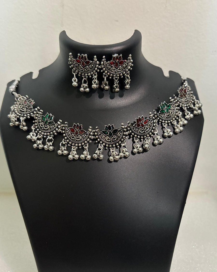 Oxidised lotus motif tassel necklace with coloured stone accents and matching lotus drop earrings
