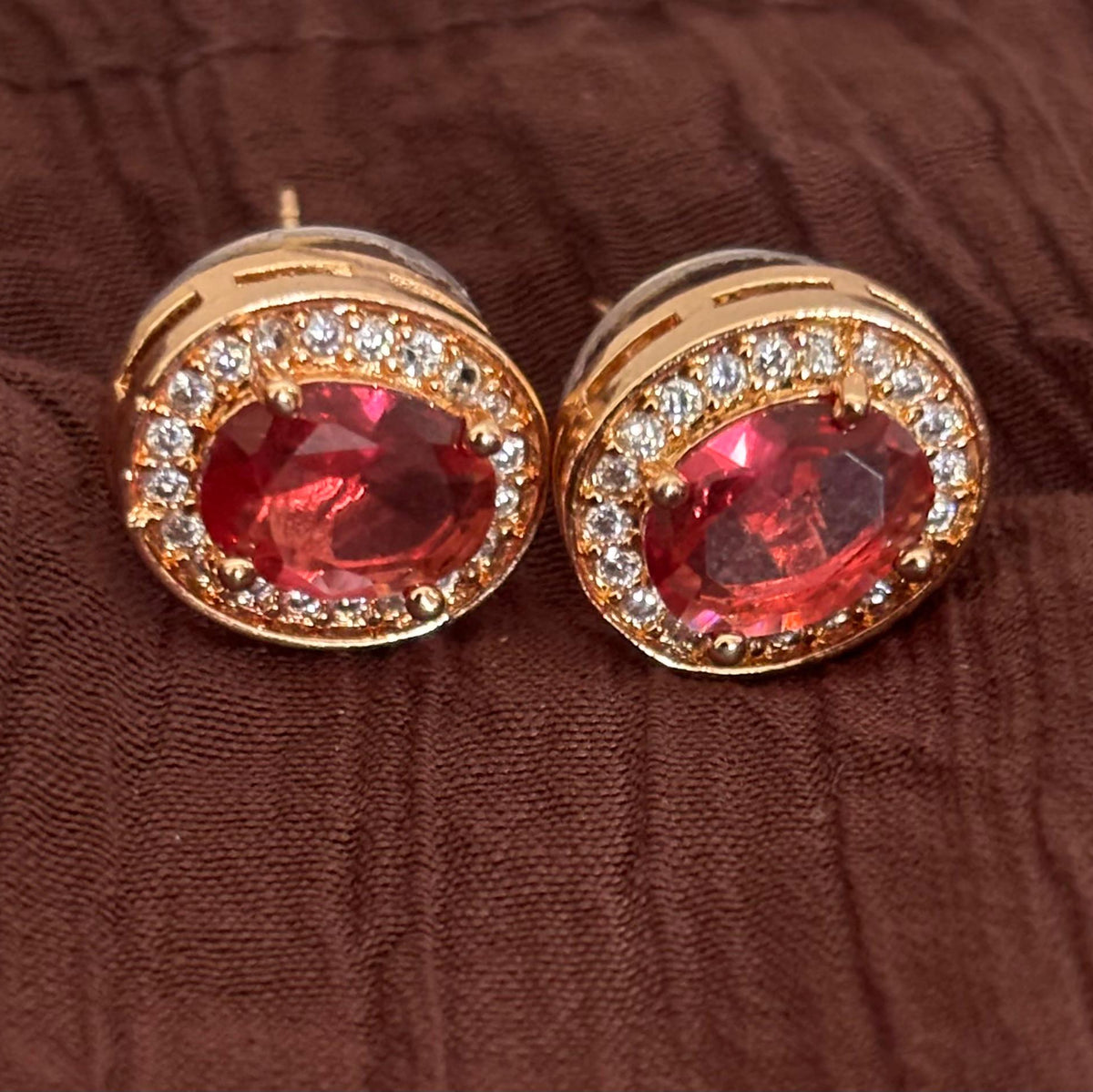 Pink AD CZ oval stud earrings with sparkling stones in a gold-tone setting