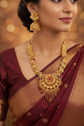 Woman wearing Kundan Ruby Circular Pendant Necklace Set with Lotus Jhumka Earrings